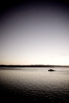 Fishing boat on the Pacific ocean at sunset (toned image).