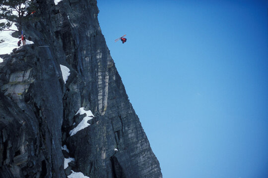 Ski-BASE jumper doing a front flip off a cliff near Lake Tahoe, California