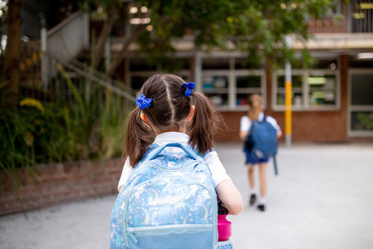 Young schoolgirl walking through playground