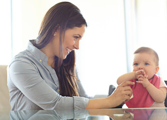 Mother, baby child and chair for play, bonding and love at table with smile, morning and happiness. Mom, infant kid and happy together in family home for development, help or care in living room