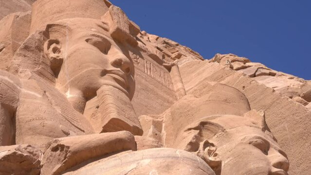 Pan down shot of Massive statue in Abu Simbel Temple