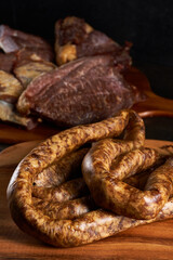 Smoked pork and sausage on wooden board