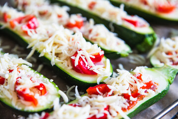 before baked zucchini with ham and vegetables, under cheese