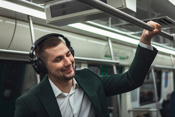 man young male caucasian passenger one person positively cheerful listens to music in headphones,...