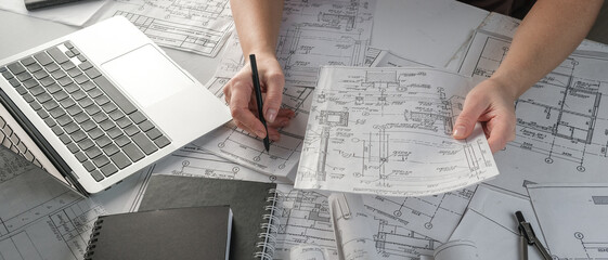 Architects concept, engineer architect designer freelance work on start-up project drawing, construction plan. architect design working drawing sketch plans blueprints and making construction model - obrazy, fototapety, plakaty