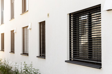 Roller Blinds on Windows of Modern House. Window with Shutter Outside. 