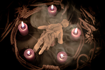 Pentagram amulet and black candle in autumn forest, natural background. Magic esoteric witches...