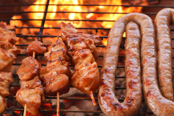 South African braai. Boerewors and chicken kebabs on a grill. 