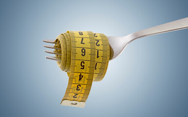 Fork with yellow measuring tape on light blue background. Concept of proper, balanced nutrition...