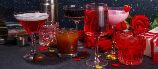 Valentine day romantic bar background. Set various red, pink, chocolate alcohol drinks for Valentine day party or dating, in different cocktail glasses with rose flower bouquet, heart decor, gift box