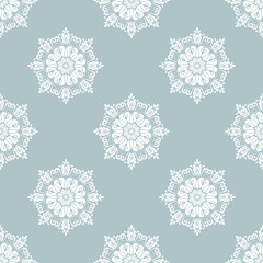 Floral ornament. Seamless abstract classic background with flowers. Pattern with repeating blue and white floral elements. Ornament for fabric, wallpaper and packaging