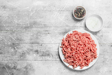 Obraz na płótnie Canvas Raw minced beef with spices.