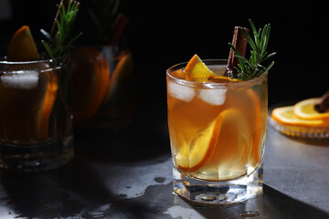 Fototapeta na wymiar Orange rosemary bourbon cocktail in low key