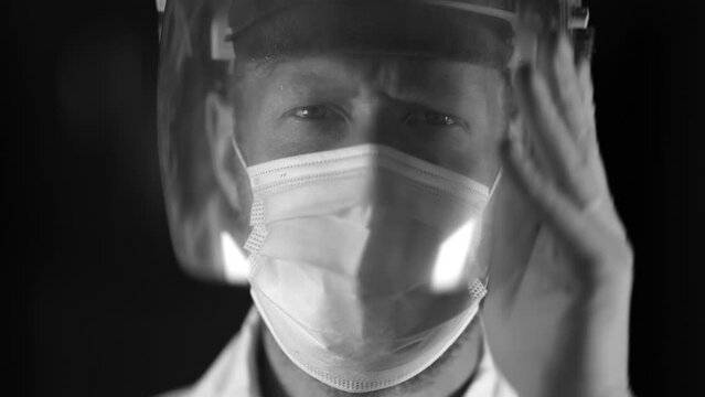 Australian person putting on safety equipment and a mask in a workplace in an industry