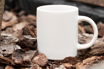 White mug in the garden. - 562098641