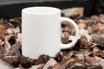White mug in the garden. - 562098661