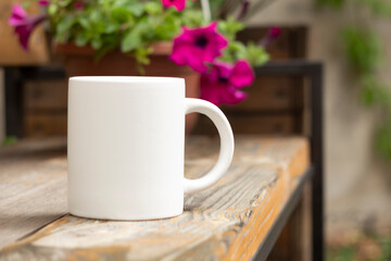 White mug in the garden. - 562098696