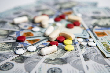 money dollars for medicine expenses in selective focus. pills of medicine expenses closeup.