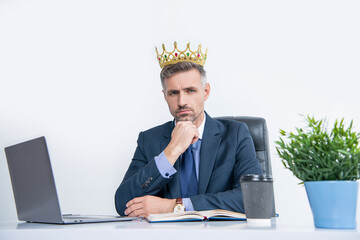 mature boss in suit and crown at the office