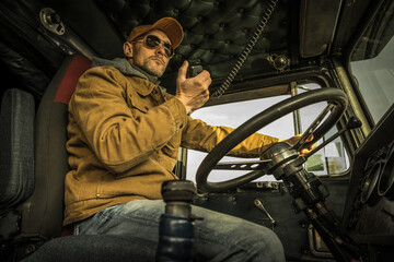 Fototapeta na wymiar Trucker Driver CB Radio Talk Inside a Truck