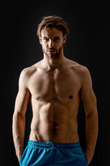 Fototapeta na wymiar muscular athletic man with abs isolated on black background. man with muscular abs in studio.