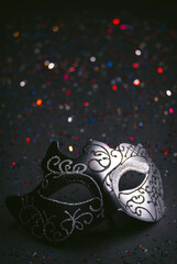 Luxury venetian mask on dark colored bokeh background.