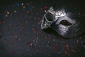 Venetian carnival mask with black glitter background