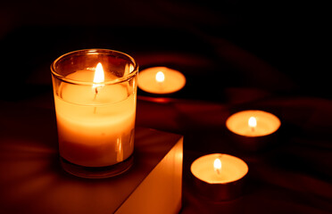 Scented candles in the dark night on a red cloth, ceremony, hope, romantic