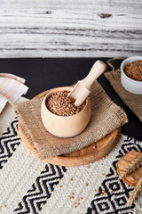 Healthy superfood, raw buckwheat porridge. Aesthetic cuisine with cutlery made of natural cotton and wood. Natural background.