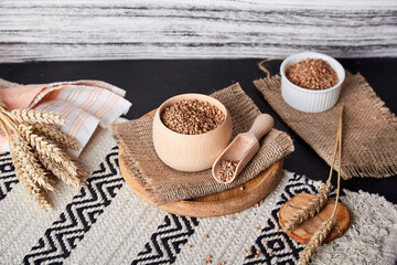Healthy natural superfood, raw buckwheat porridge. Aesthetic cuisine with cutlery made of natural cotton and wood. Natural background.