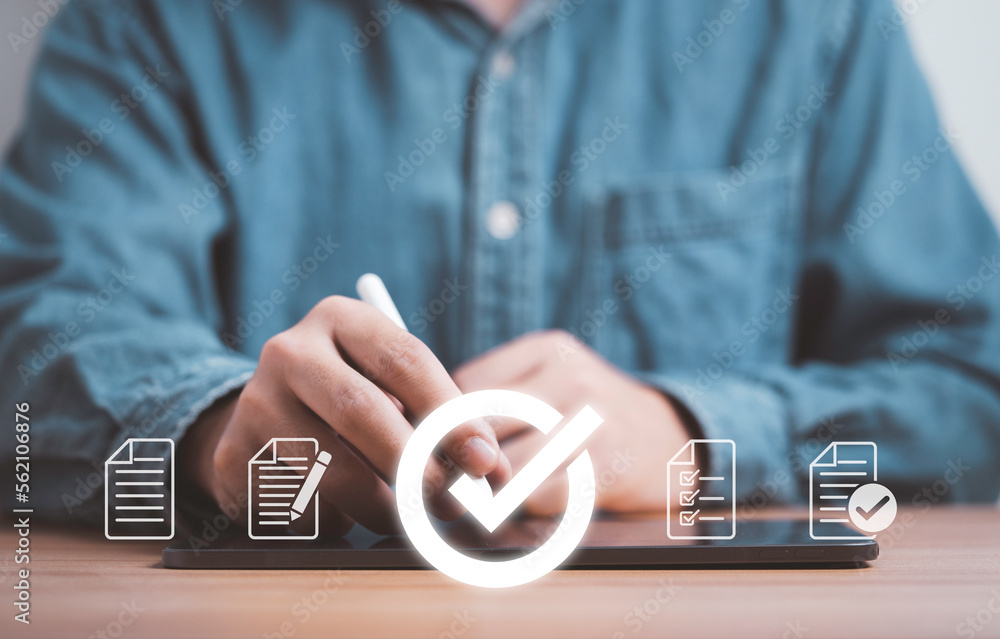 Poster Businessman using electronic pen and tablet with correct sign mark and document icon for prepare check and approve document , Quality assurance and ISO guarantee concept.