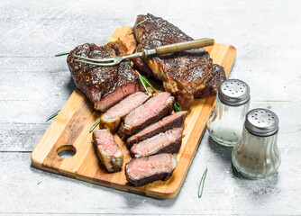 Grilled beef steak with rosemary and spices.
