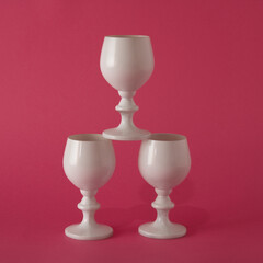 Together we can do everything! White wine glasses on a pink background arranged like a Christmas tree