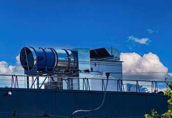 Ventilation system on the roof of an industrial building. Room ventilation. Industrial equipment. Ventilation of office centers. The roof of the building. Air injection. Blower fan.