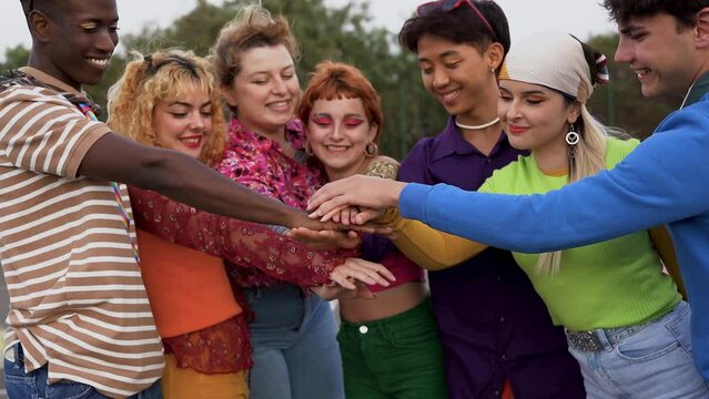 Multiethnic friends stacking hands outdoor
