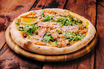 Italian Pizza with salmon, arugula and capers