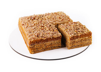 Carrot cake with walnuts on white plate