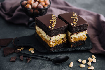 Fluffy snickers cake on stone board