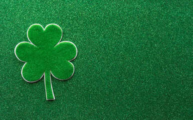 Happy St Patrick's Day decoration concept made from shamrocks ( clover leaf) on green background.