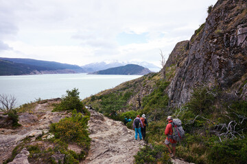 group of hikers walking the trail on the way to glacier Grey in Torres del Paine National Park