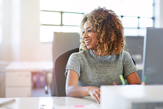 Thinking, working and motivation with a business black woman sitting her desk in the company office. Idea, inspiration and vision with a young female employee at work on a target or goal