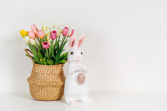 Spring flowers, Easter Bunny and eggs. Home interior with easter decor.   Children's room in the Easter style. Holidays decorations.