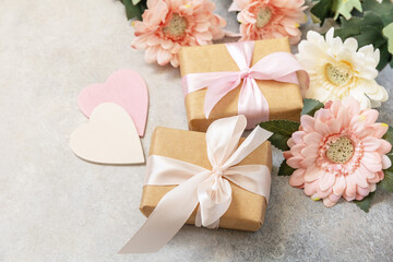 Valentine's Day background with gifts, beautiful flowers and hearts. Valentine's day, Womans day, wedding, birthday or mothers day greeting card. Copy space.