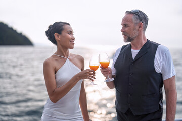 Romantic couple in love have fun sailing in the sea standing on yacht deck enjoy amazing view
