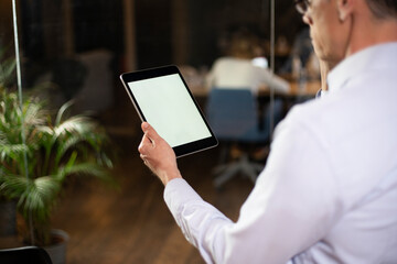  Close up of man using digital tablet.