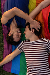 Happy young couple embraces. Two men enjoy in the park