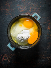 Flour with eggs in the pan.