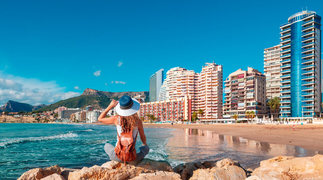 Woman on the beach looking at Calpe city landscape- Alicante province in Spain