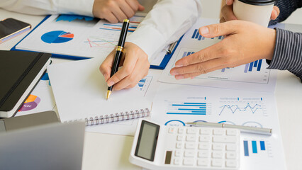 Group of businessmen holding smart pen discussing in group meeting at table in modern office with graph papers and laptop Strategic Planning, Business Collaboration and Brainstorming of Colleagues