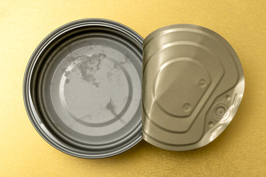 Old tin can for food on golden metal background